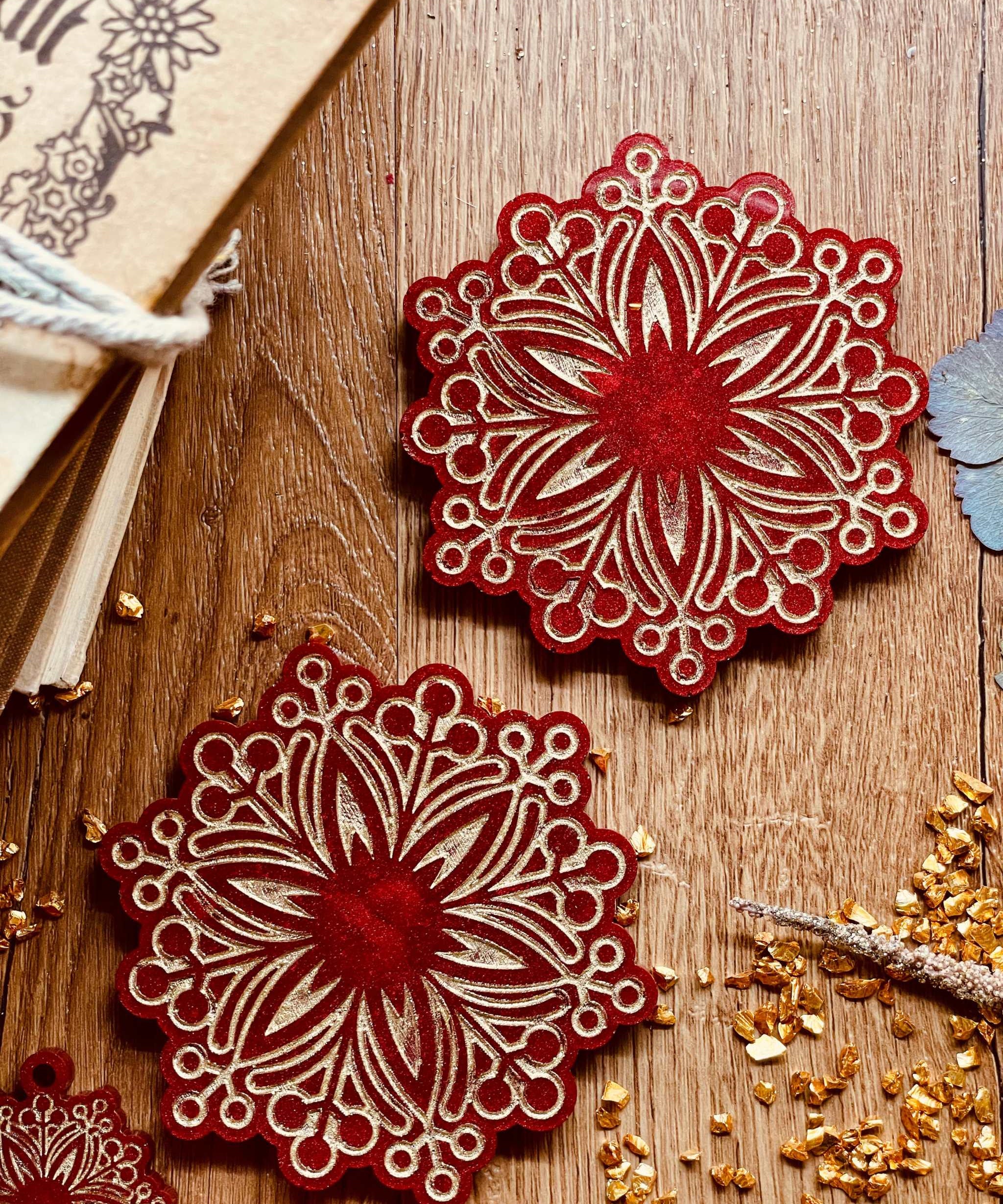 Handmade red and gold resin coasters for Christmas decor.