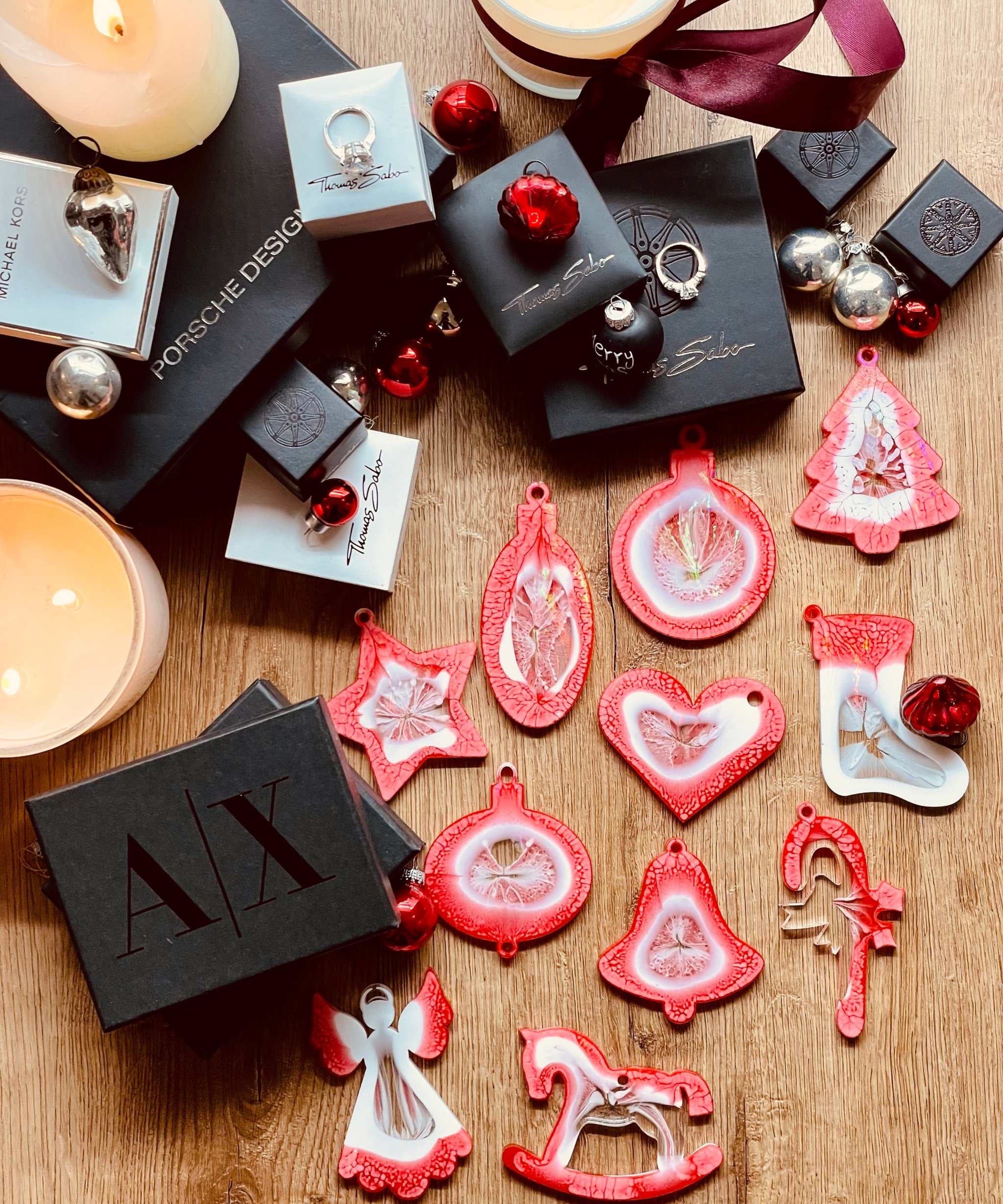 Handmade red and white resin Christmas tree ornaments with holographic surface.