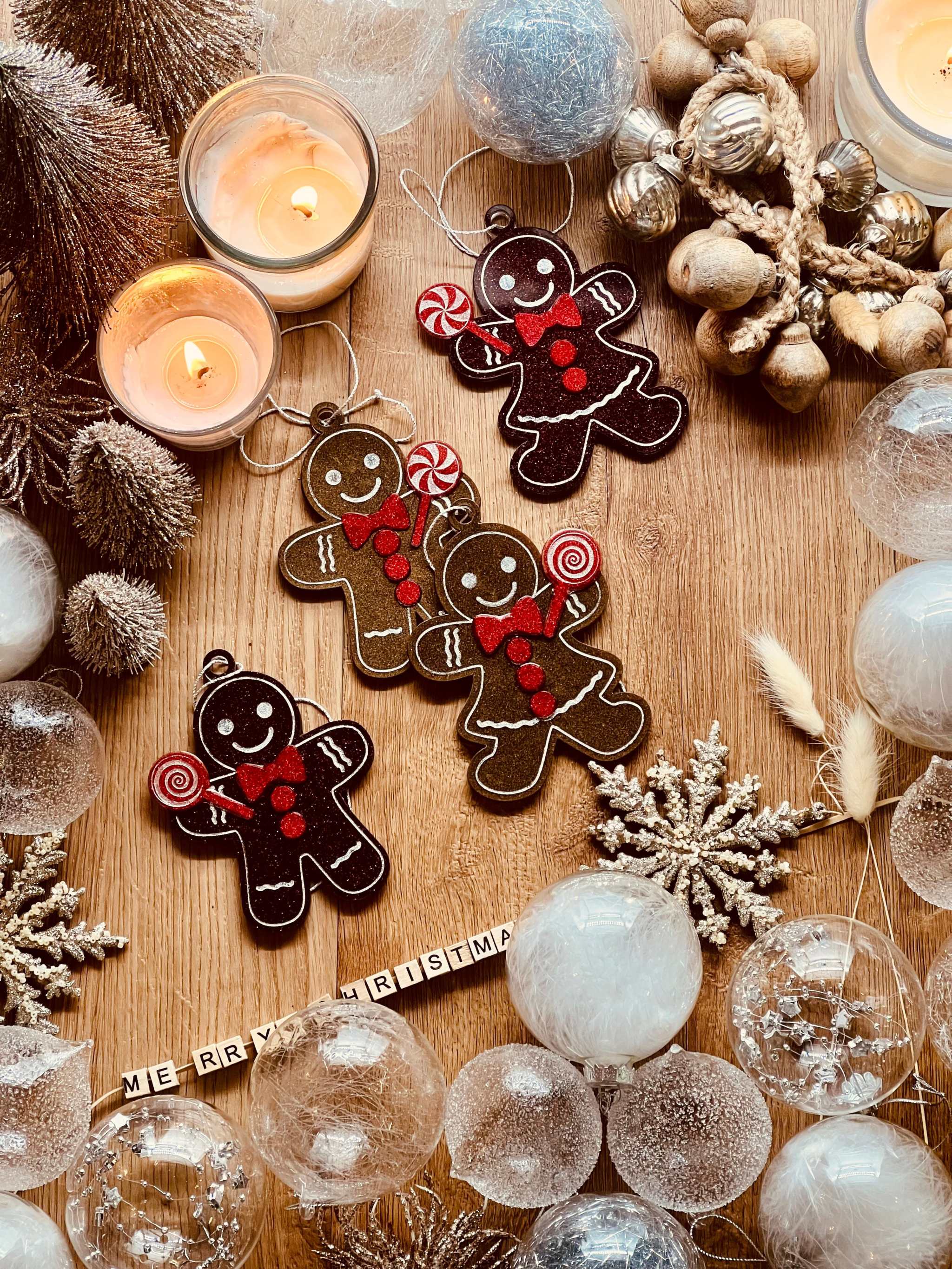 Handmade resin gingerbread men Christmas tree ornaments in brown and red tones.