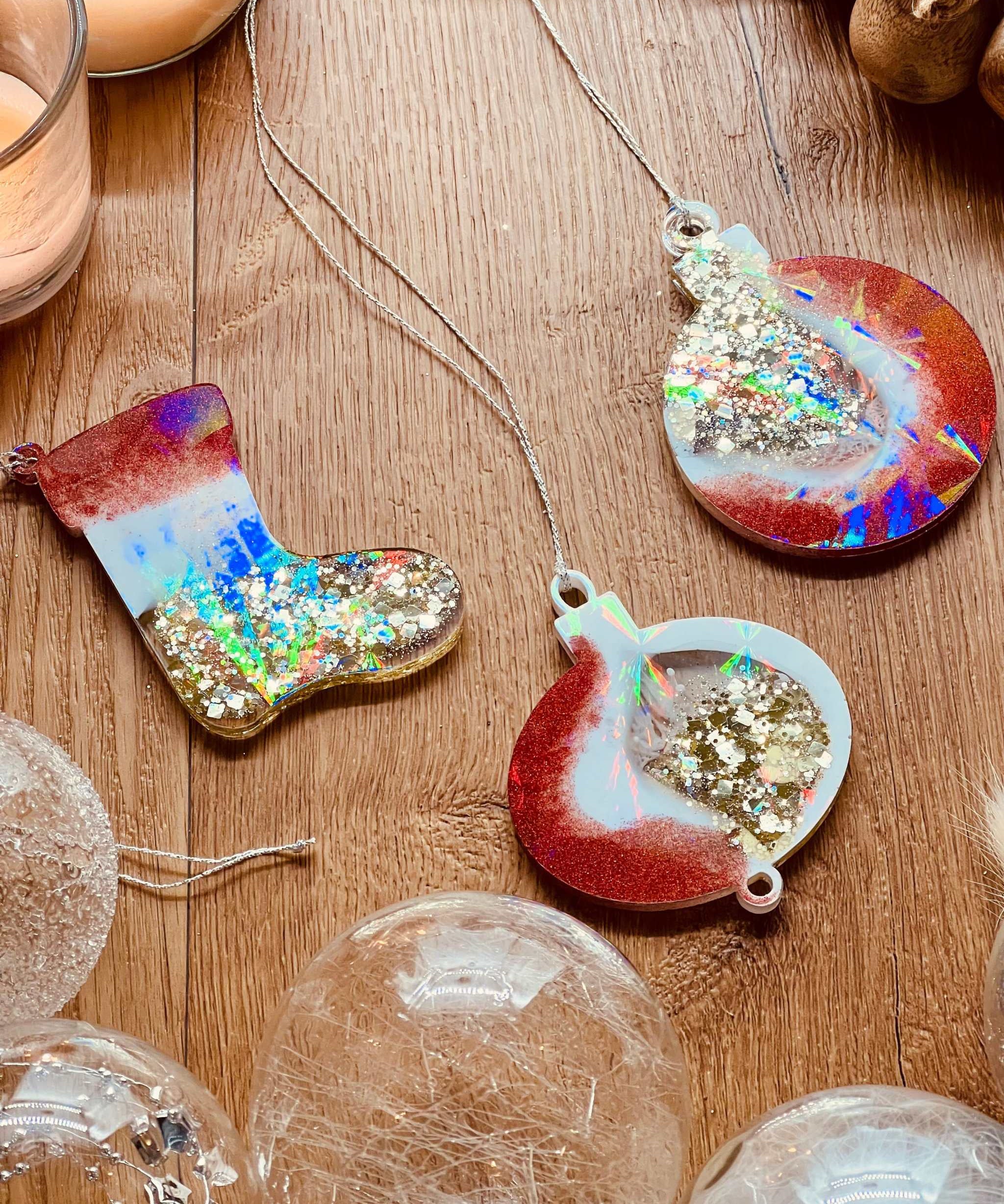 Handmade resin Christmas tree ornaments in red, gold, and white with holographic surface, set of three.