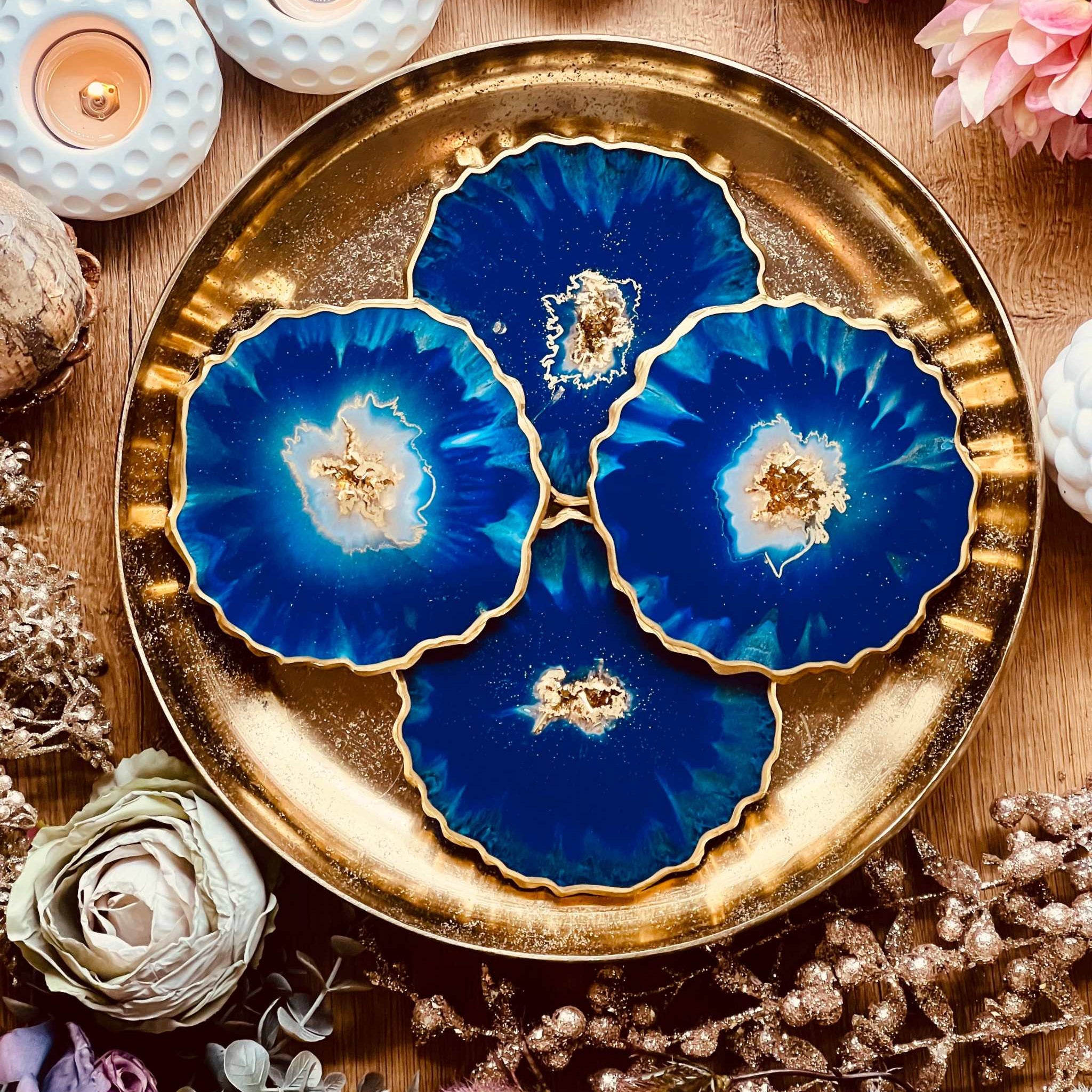 4 resin coasters in blue with gold