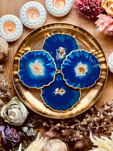 4 resin coasters in blue with gold