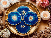 4 resin coasters in blue with gold