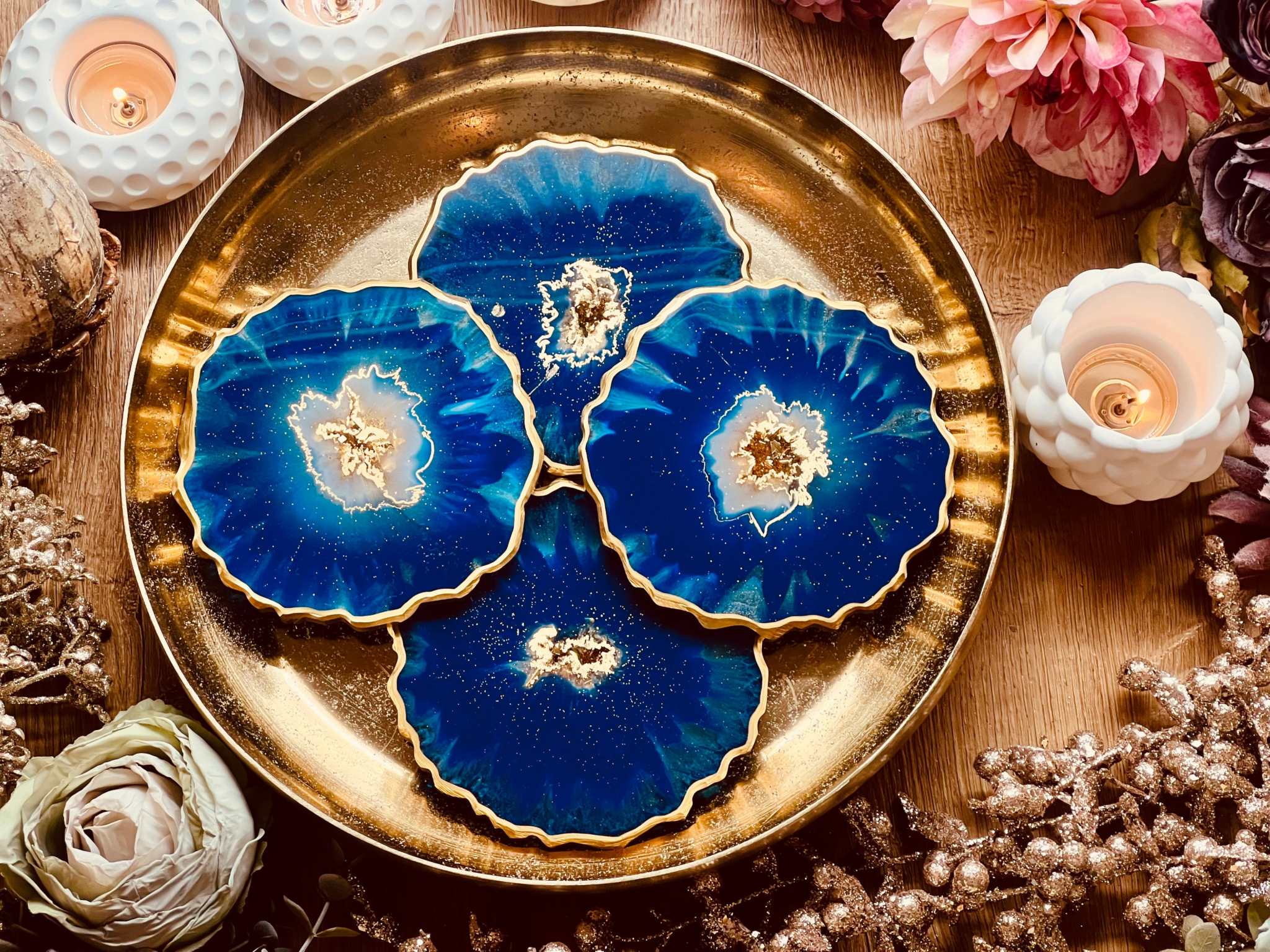 4 resin coasters in blue with gold