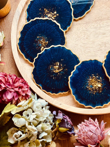 6 resin coasters in blue with gold