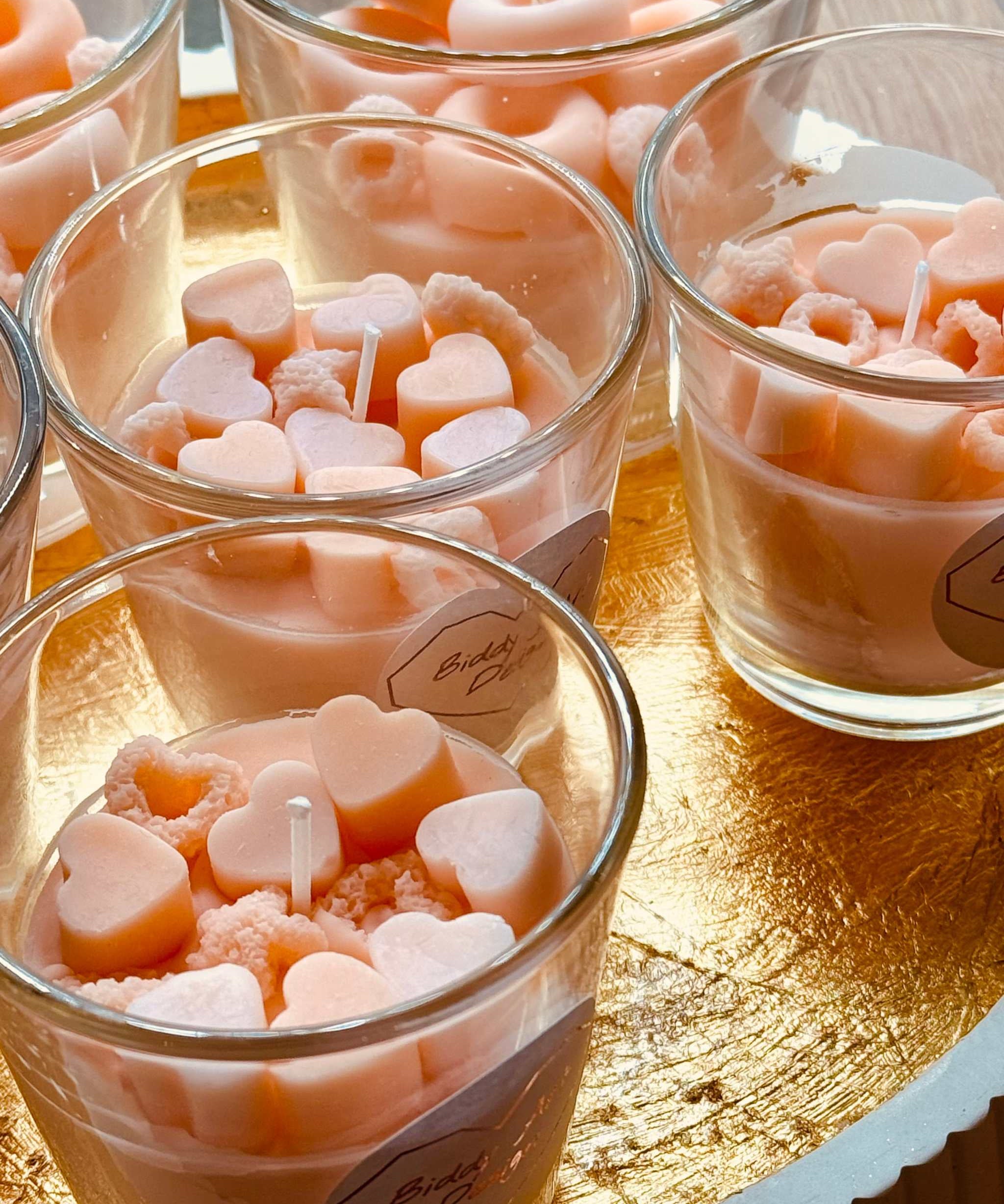 Glas-Duftkerze in Pink und Rosa, verziert mit Bonbons aus Wachs – ideal als kreatives Geschenk und duftender Akzent für Zuhause