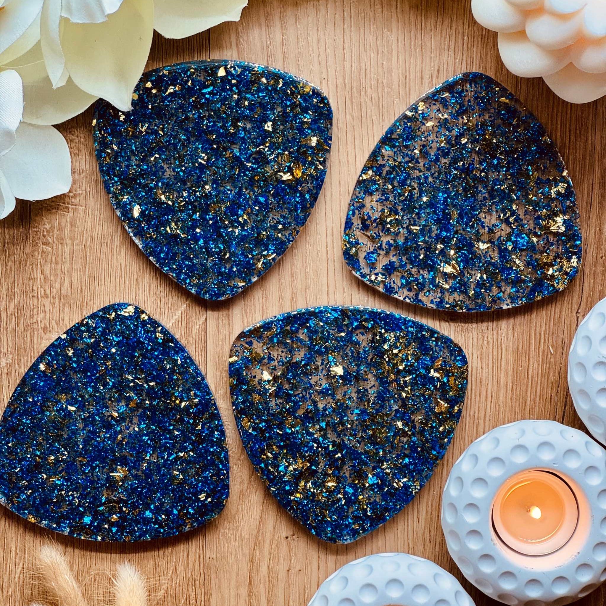 4 resin coasters in blue with gold