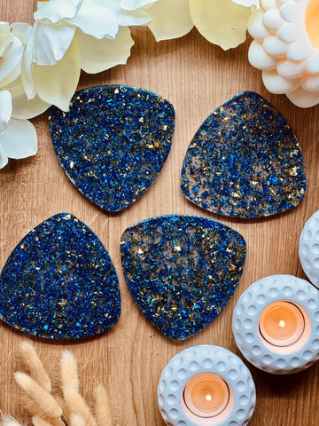 4 resin coasters in blue with gold