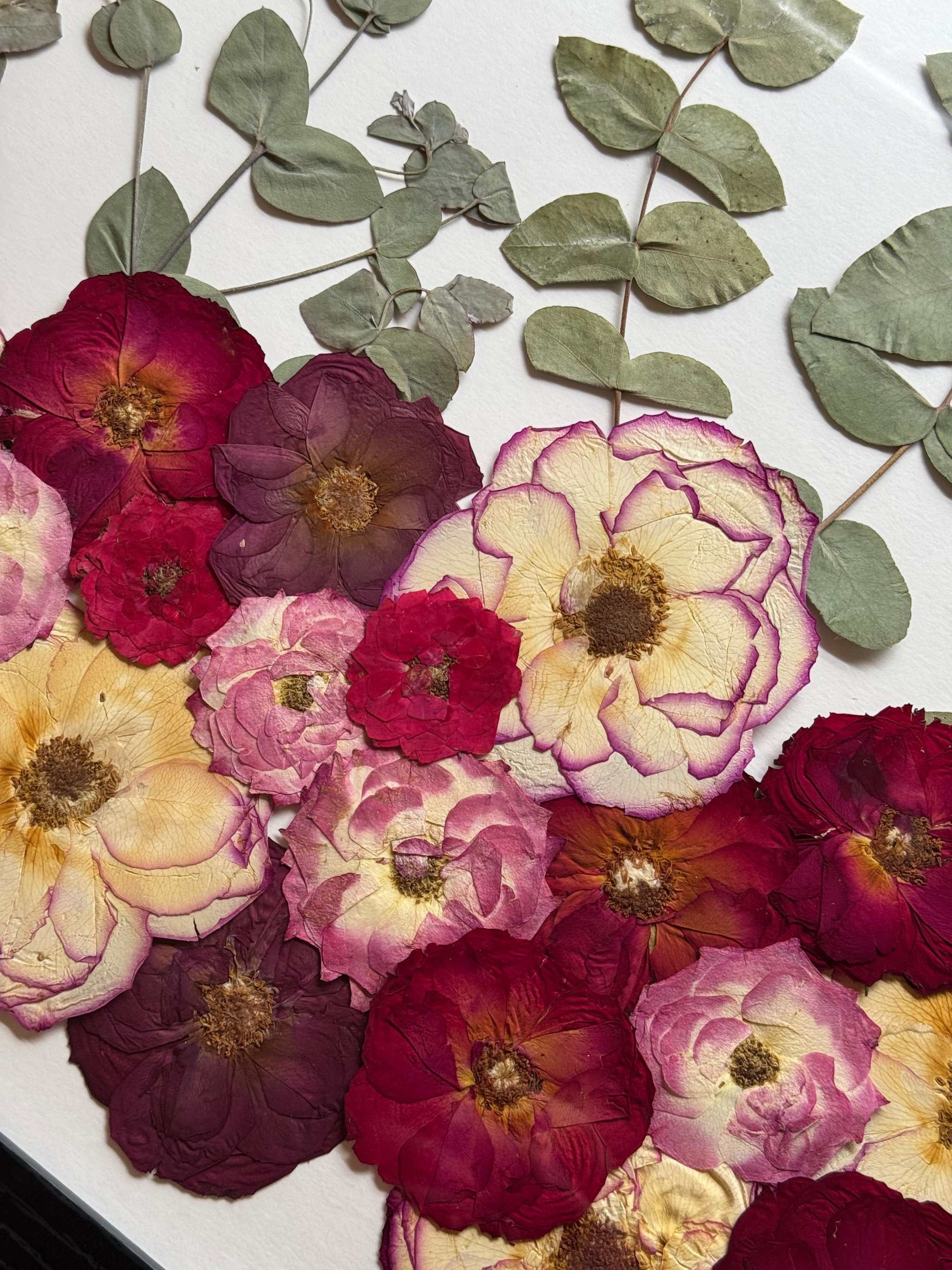 Kreativ gestalteter Hochzeitsblumen Bilderrahmen mit verschiedenen floralen Elementen – Brautstrauß konservieren und kunstvoll weiterleben lassen.