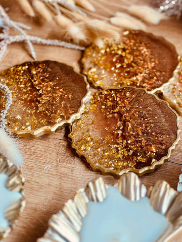 4 resin coasters in brown with gold