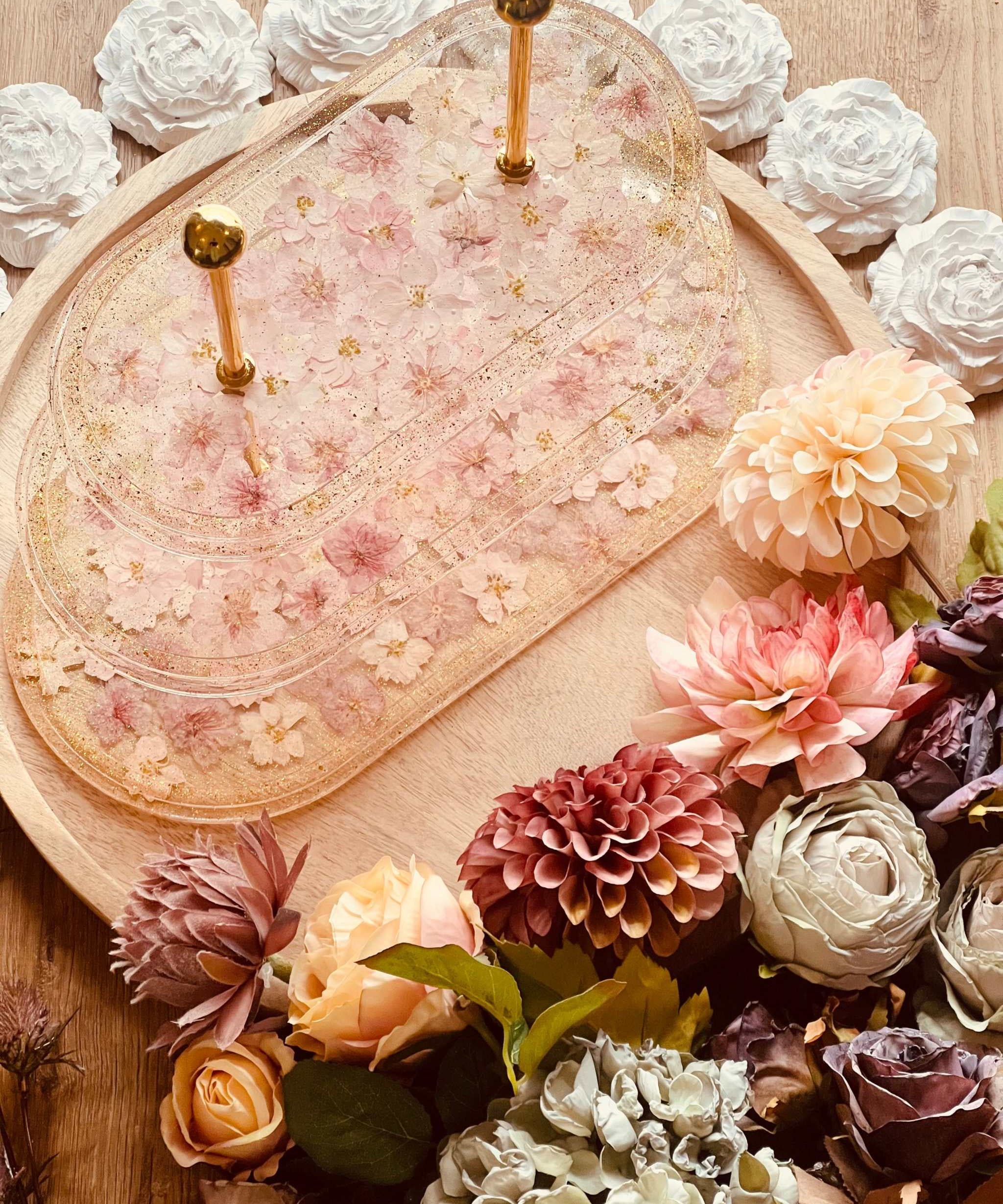 Handgefertigte ovale Resin Etagere mit zarten rosa Blüten und schimmerndem Goldstaub – edle Tischdekoration und Geschenkidee für besondere Anlässe.