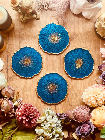 4 resin coasters in blue with gold