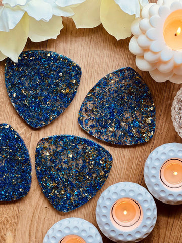 4 resin coasters in blue with gold