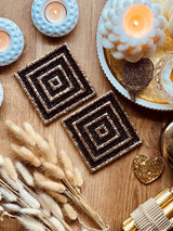 2 resin coasters in black and gold 3D design