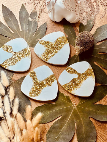 Cast ceramic coasters in glittering gold leaf design