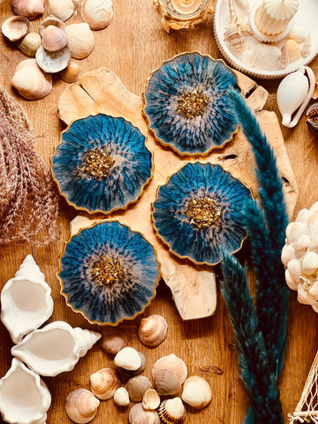 4 resin coasters in blue with gold
