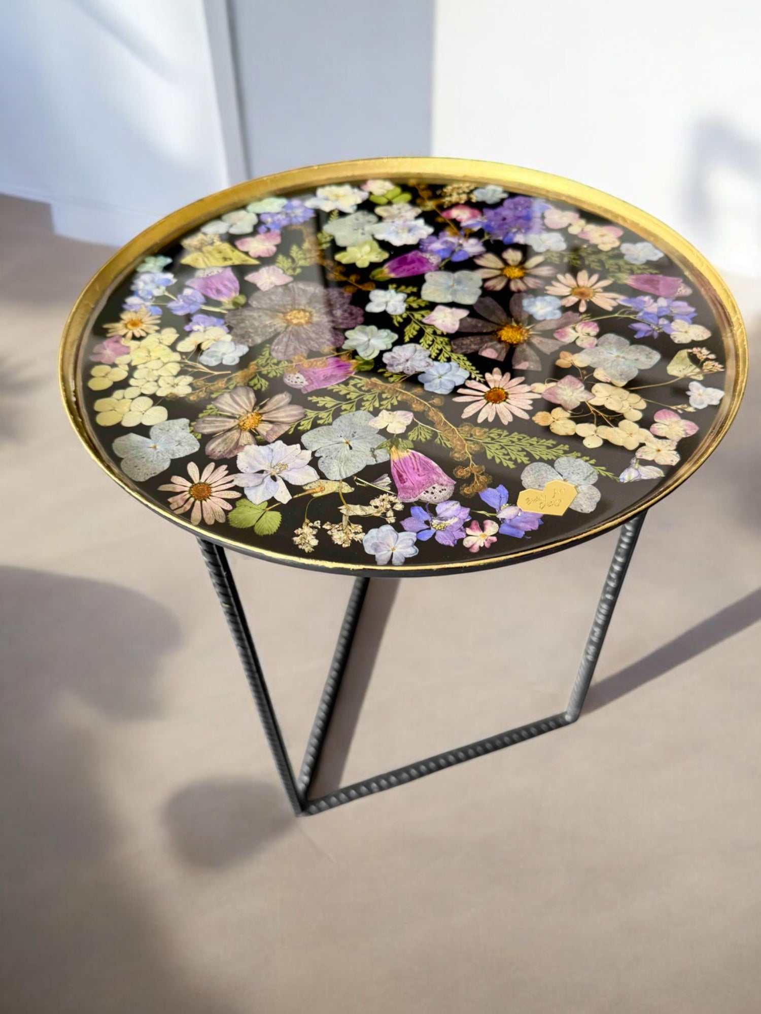 Runder Epoxidharz Couchtisch mit schwarzem Metallfuß und bunter Blumenplatte – elegantes Designobjekt, liebevoll mit Resin versiegelt