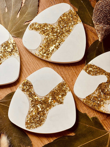 Cast ceramic coasters in glittering gold leaf design