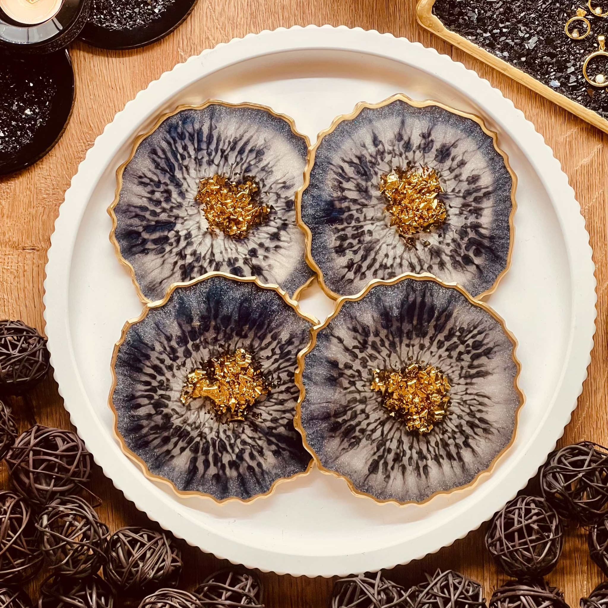 4 resin coasters in blue with gold