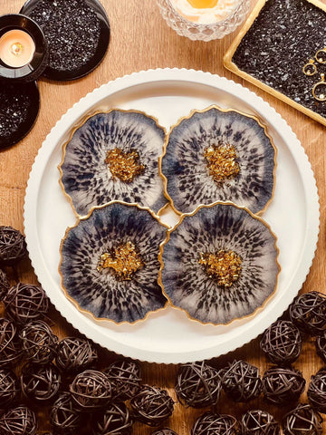 4 resin coasters in blue with gold