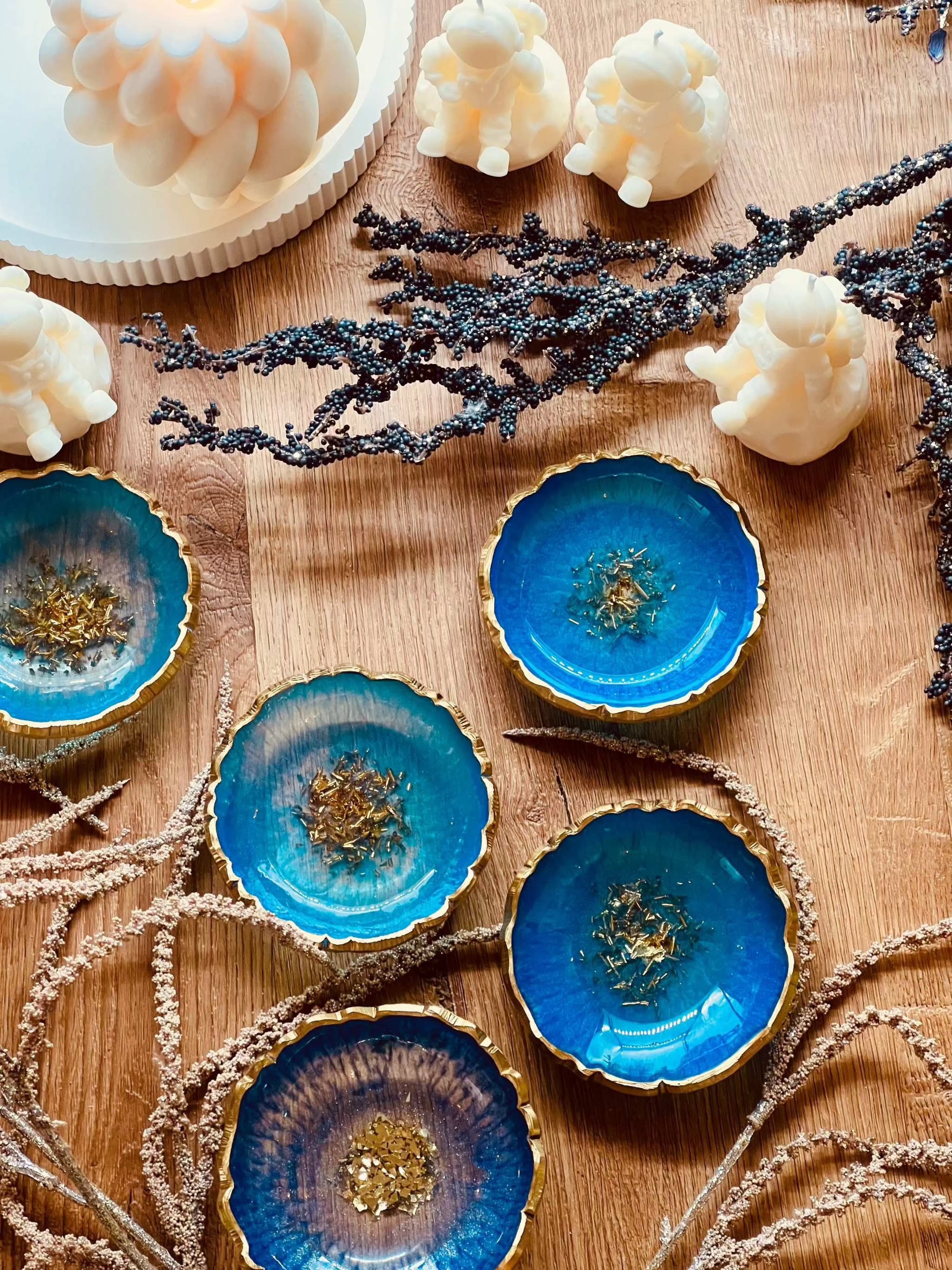 Handgemachte Schmuckschalen aus Resin in Blau und Türkis mit goldenen Details auf Holztisch dekoriert