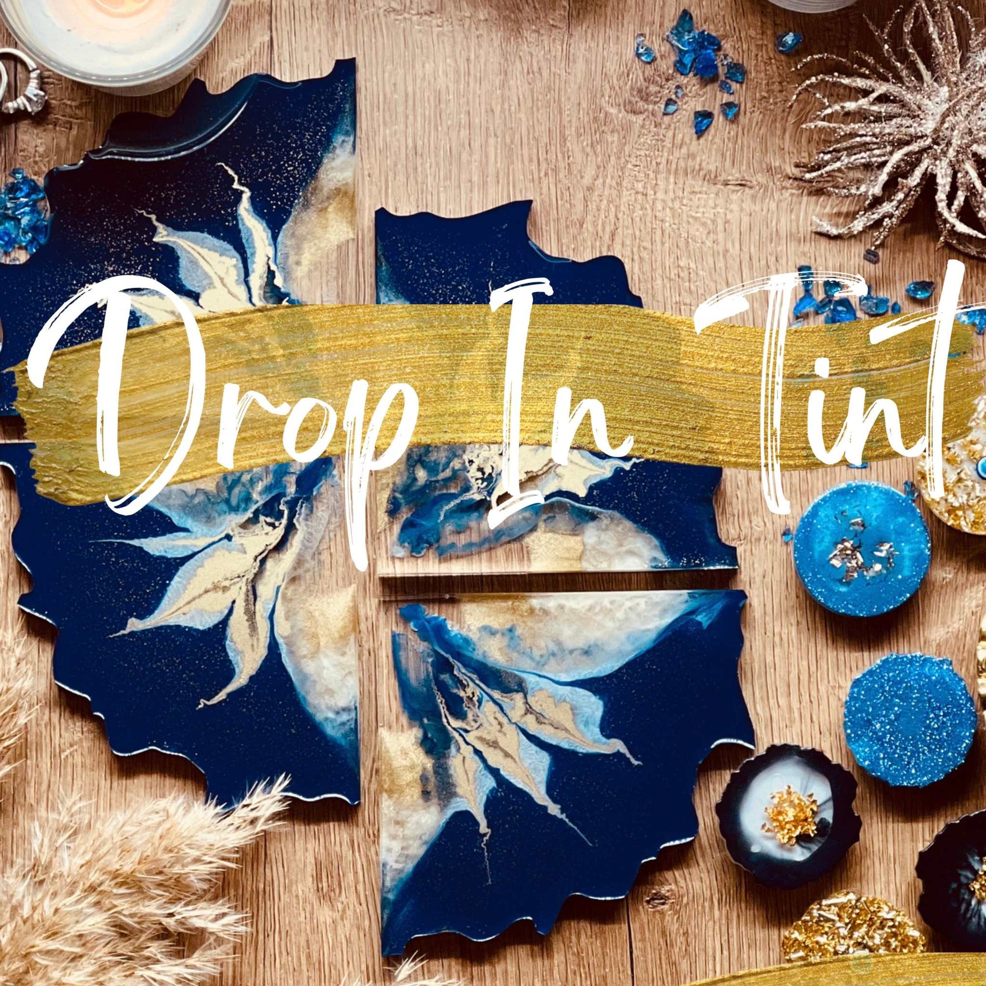 Resin art pieces with drop-in tints, featuring blue and gold designs for an online resin art course.