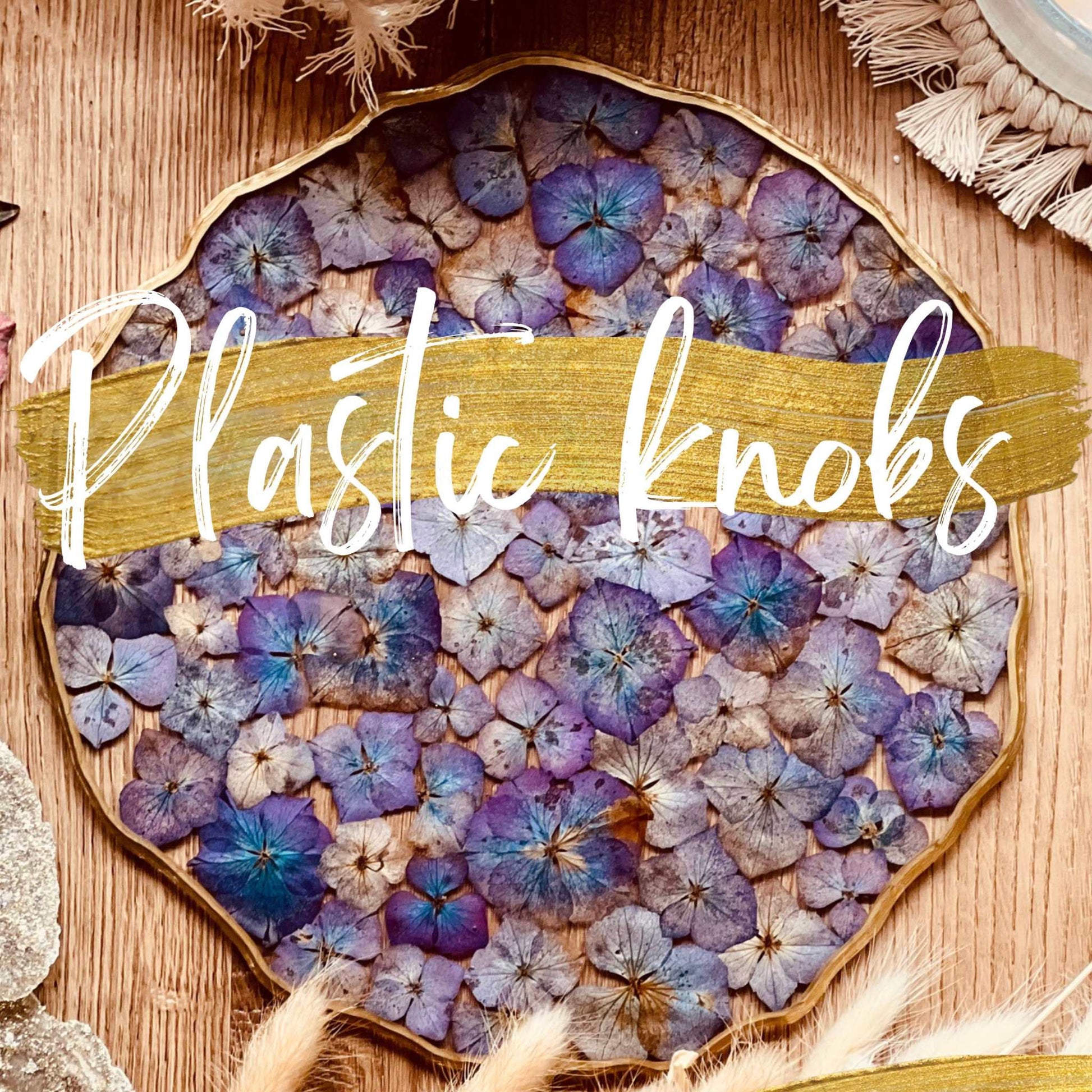 Resin art with purple and blue dried flowers on tray.