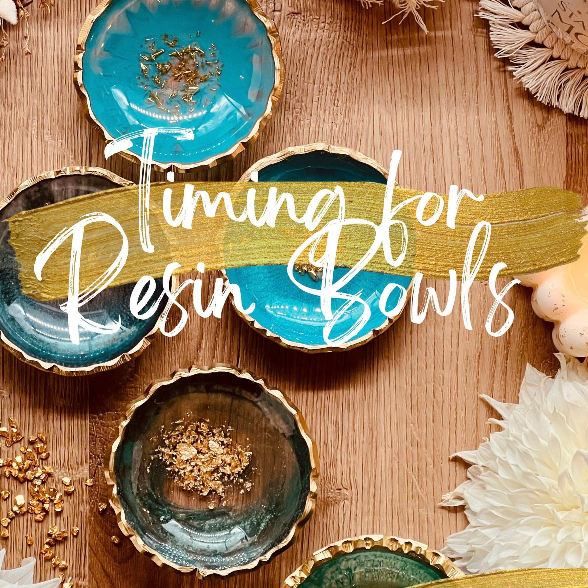 Resin art bowls with gold accents displayed on a wooden surface, highlighting timing techniques.