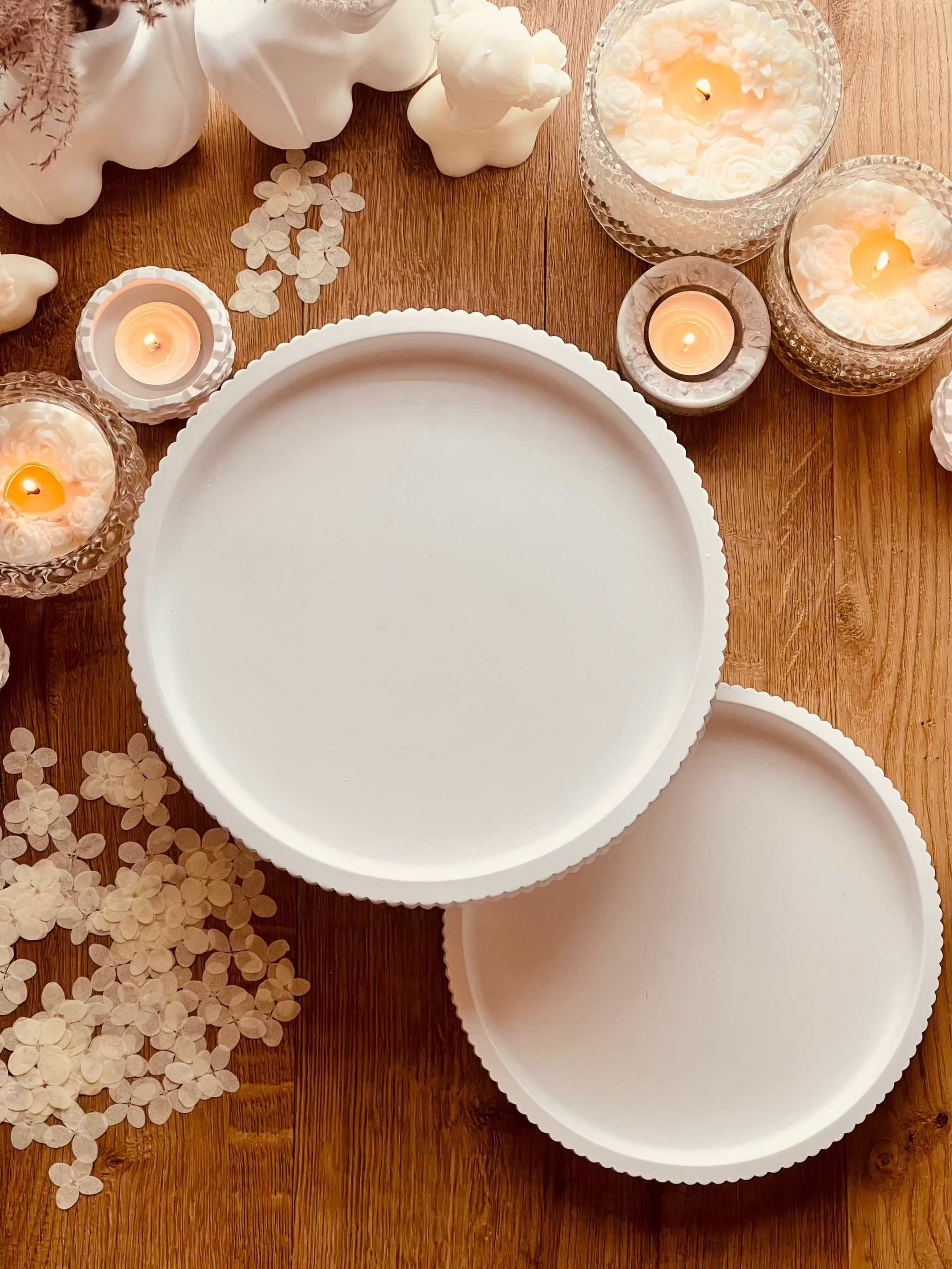 Modern ceramic tiered tray with stripe design on wooden table surrounded by candles for versatile decor.