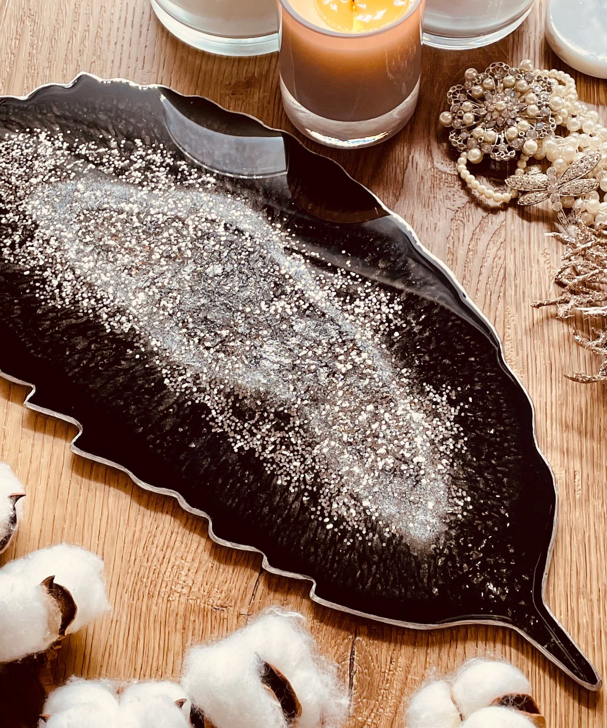 Schwarzes Feder Tablett aus handgemachtem Resin mit silbernen Details auf Holztisch dekoriert