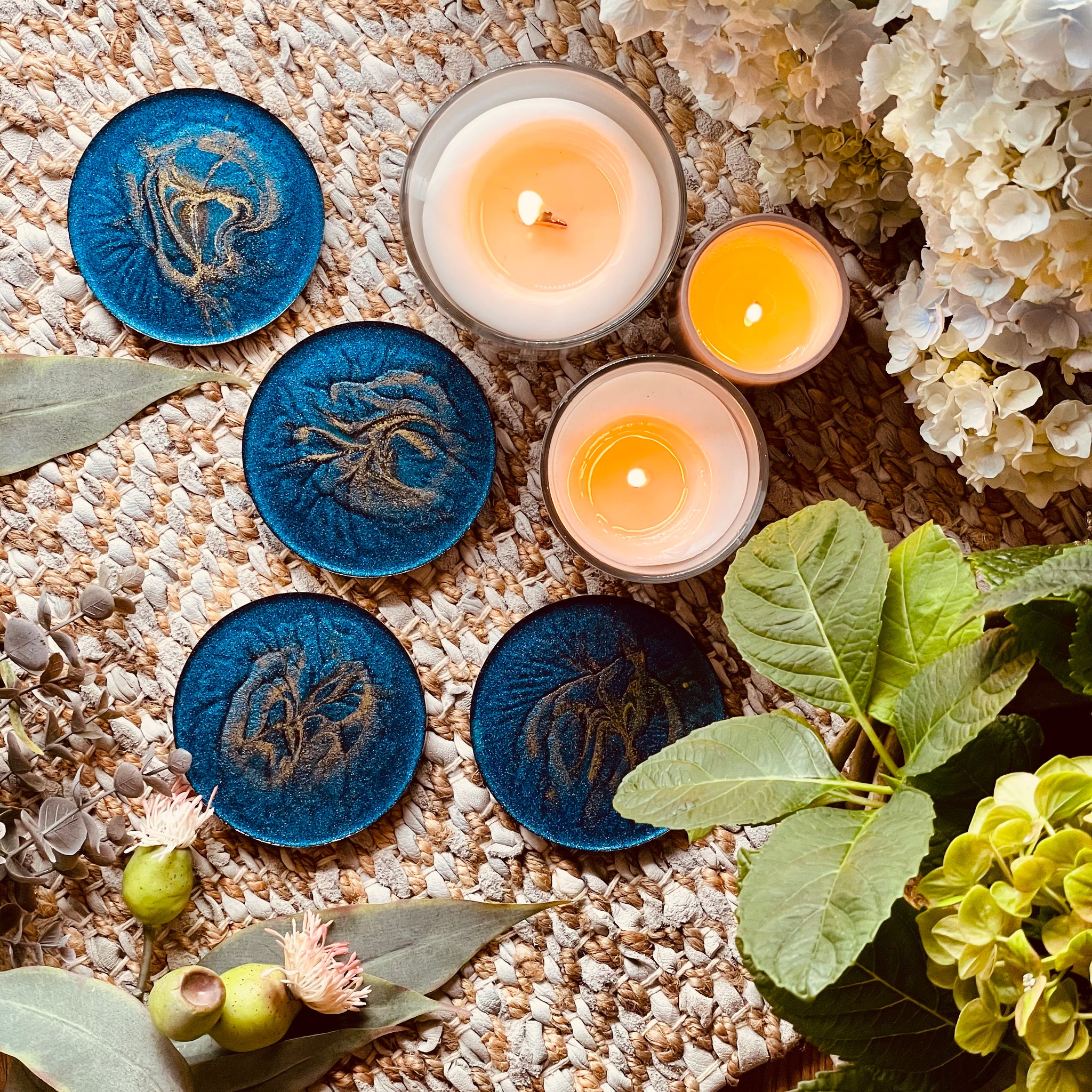 4 resin coasters in blue with gold