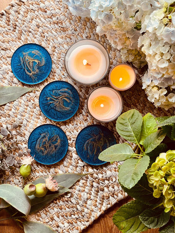 4 resin coasters in blue with gold