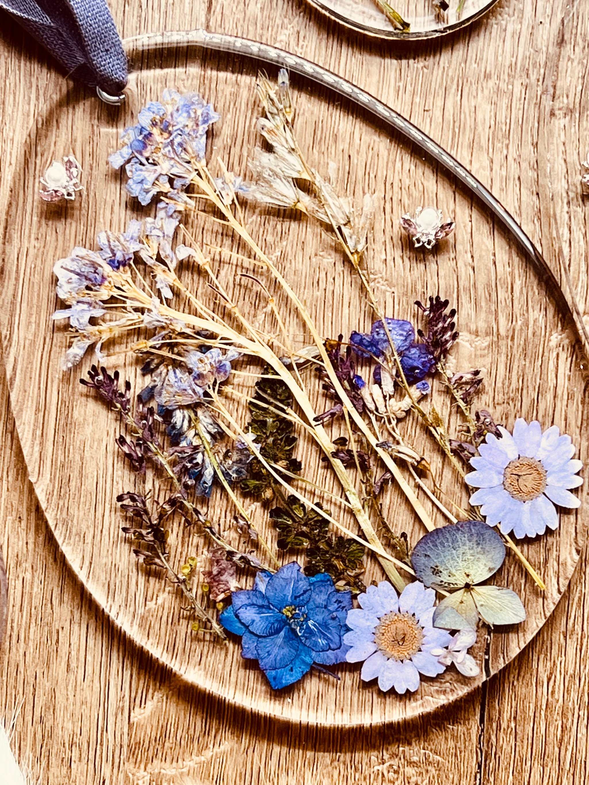 Handmade resin Easter egg pendant with dried plants.