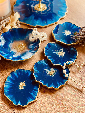 4 resin coasters in blue with gold