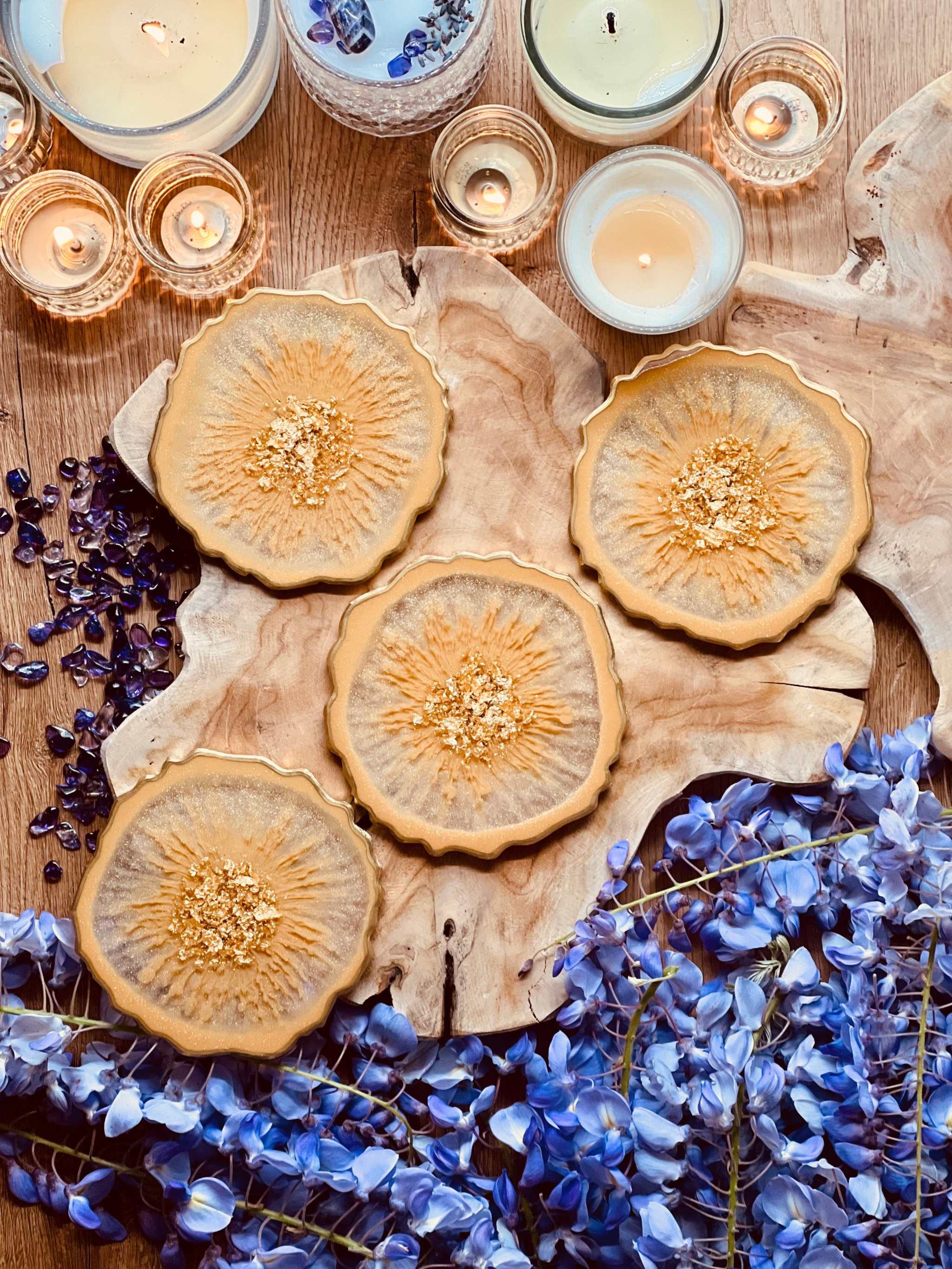 4 handgemachte Untersetzer aus beige-goldenem Resin, rund, Durchmesser 12cm, dekorativ auf Holztisch mit Kerzen und blauer Deko