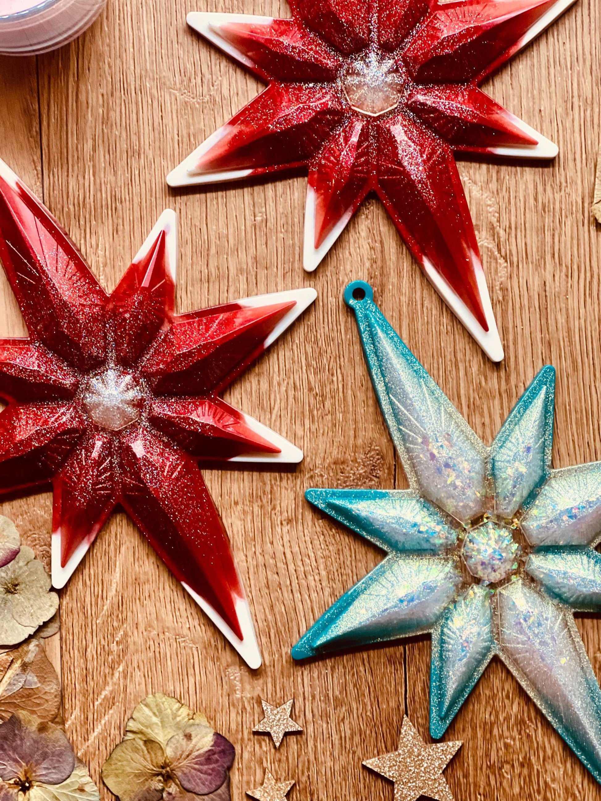 Handmade resin Christmas tree ornaments in red or turquoise with white and silver accents, approximately 23x18cm.