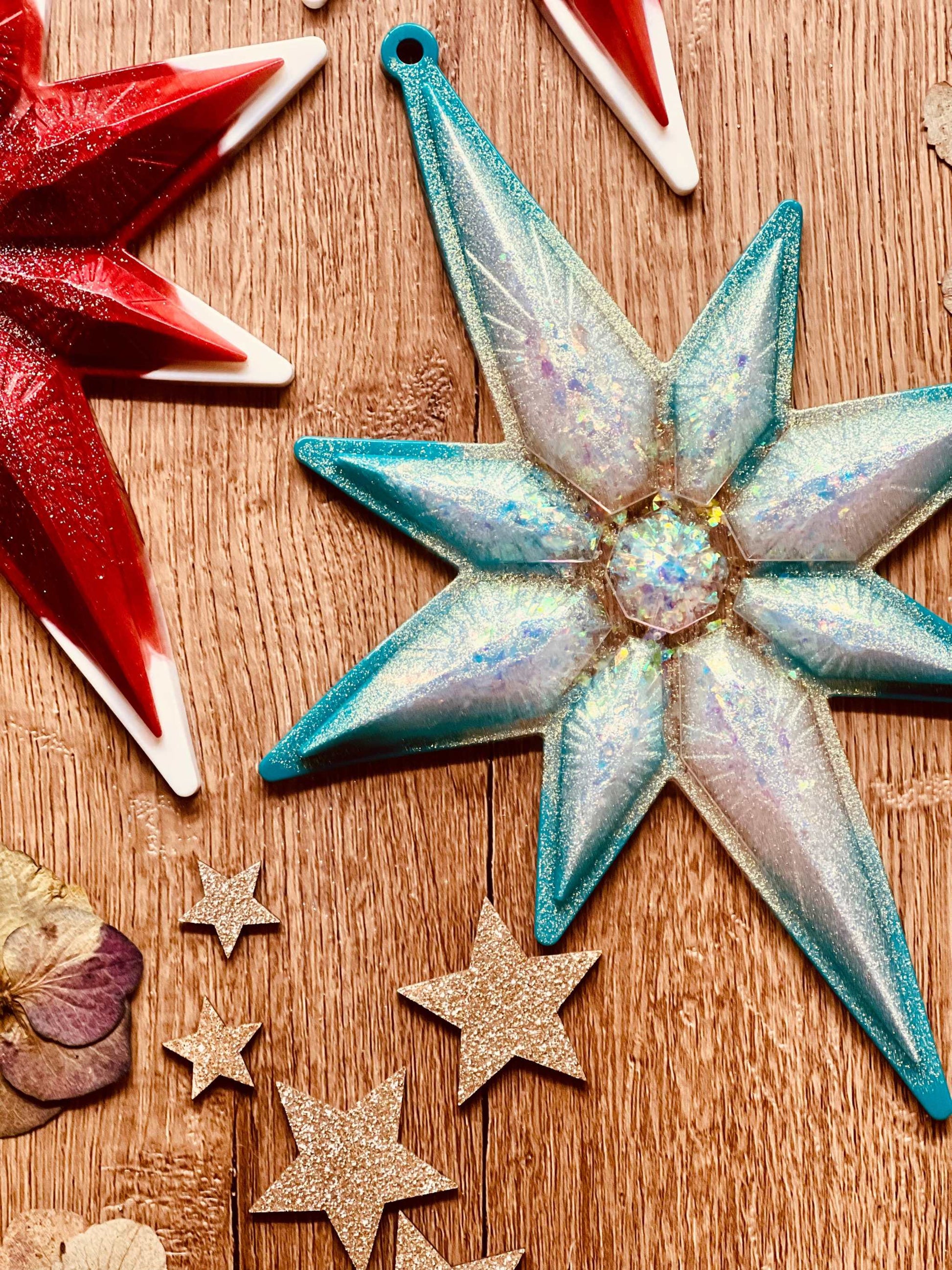 Handmade resin Christmas tree ornaments in red or turquoise with white and silver accents, unique and eye-catching decorations.