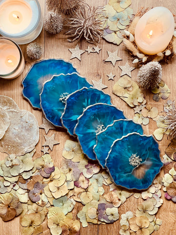 6 resin coasters in blue with silver