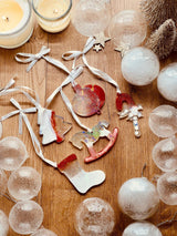 5 red and white resin charms with holographic finish