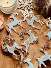 Handmade white and gold resin reindeer Christmas tree ornaments.