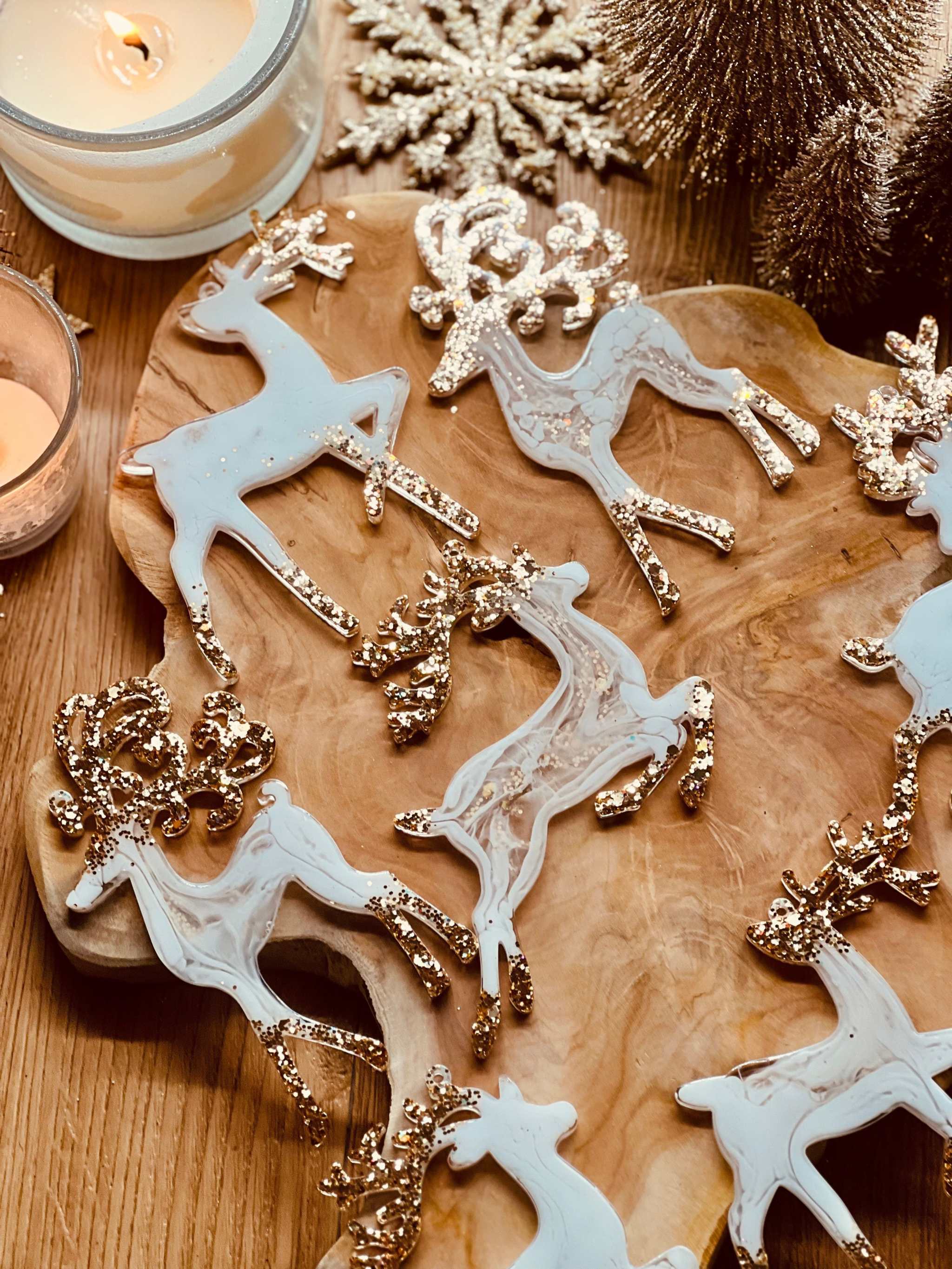 Handmade white and gold resin reindeer Christmas tree ornaments.