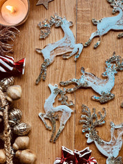 Handmade white and silver resin reindeer Christmas tree ornaments.