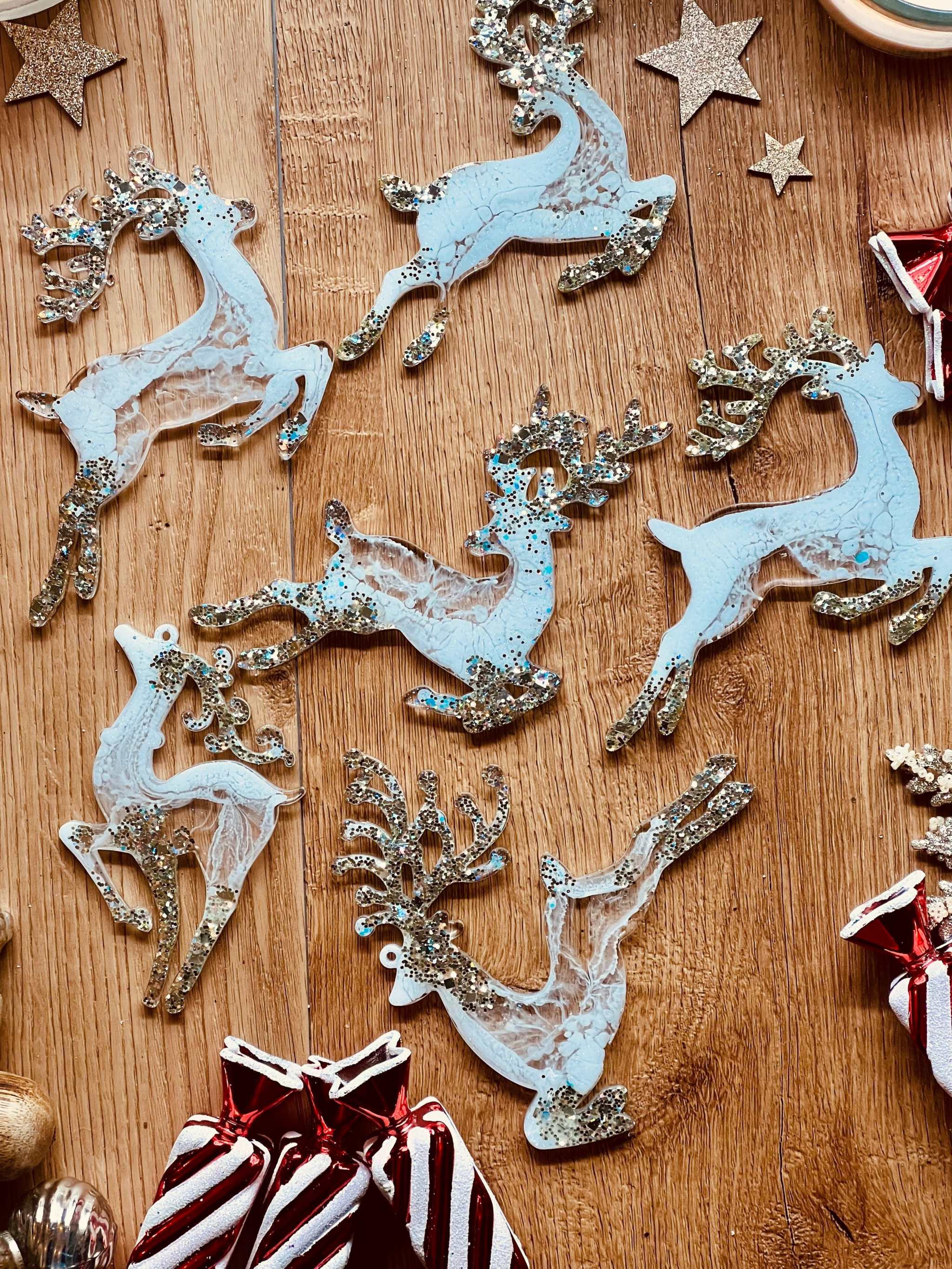 Handmade white and silver resin reindeer ornaments for Christmas trees.