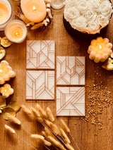 4 white resin coasters with gold 3D design