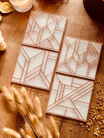 4 white resin coasters with gold 3D design