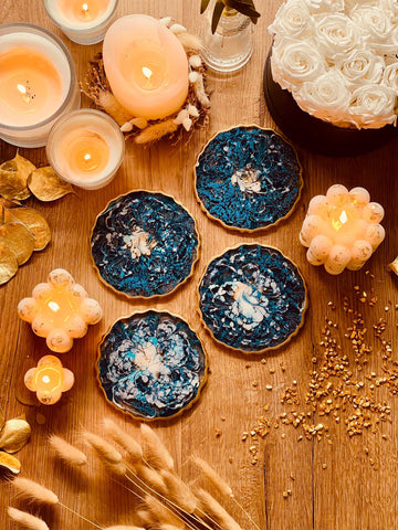 4 resin coasters in blue with gold
