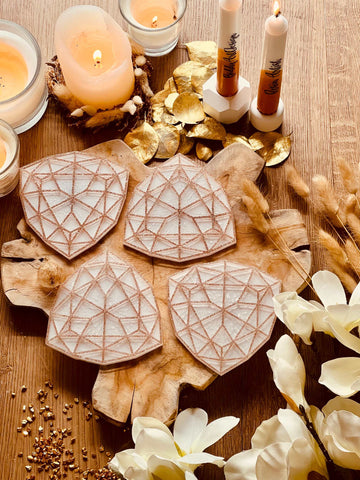 4 white resin coasters with gold 3D design