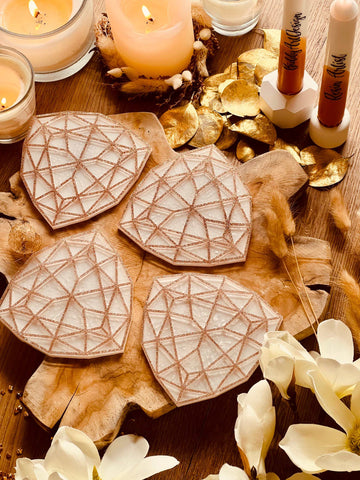 4 white resin coasters with gold 3D design