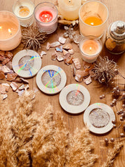 5 handgemachte weiße Untersetzer aus Resin mit silbernen Details und holographischem Design auf Holztisch mit Kerzen und Deko