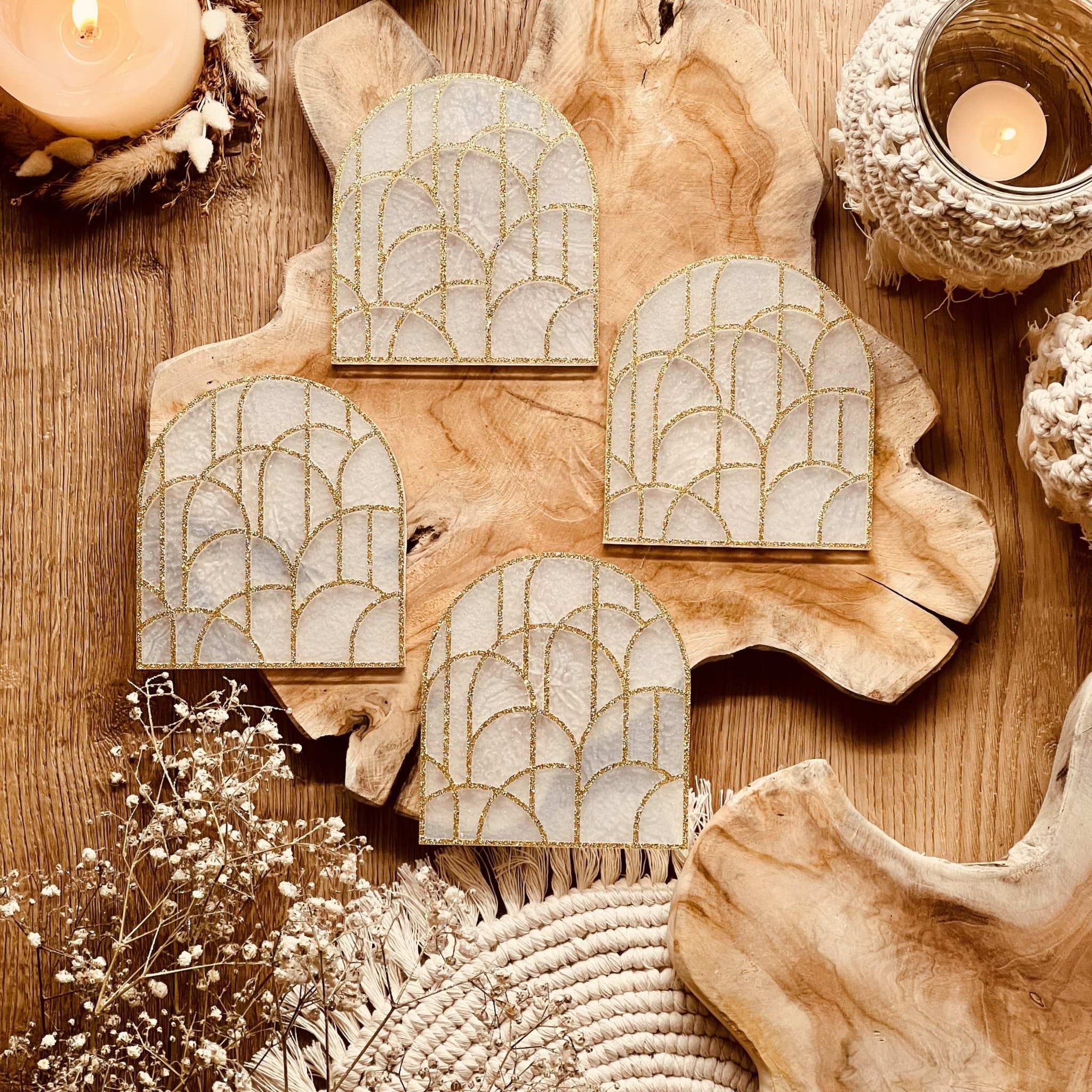 4 white resin coasters with gold 3D design